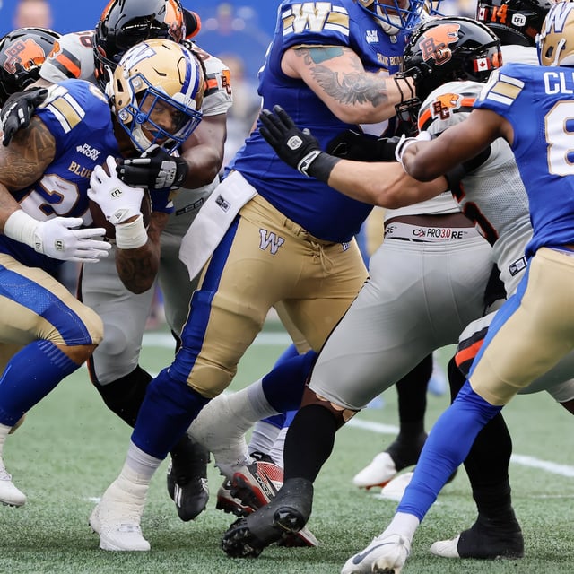 Winnipeg Blue Bombers' Brady Oliveira (20) runs for the first down during first half CFL action against the BC Lions in Winnipeg Thursday, June 12, 2025. THE CANADIAN PRESS/John Woods