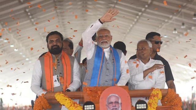 Prime Minister Narendra Modi waves to the crowd on his way to address a public rally with Bihar Chief Minister Nitish Kumar and Deputy Chief Minister Samrat Choudhary in Siwan, Bihar. (Santosh Kumar/HT)
