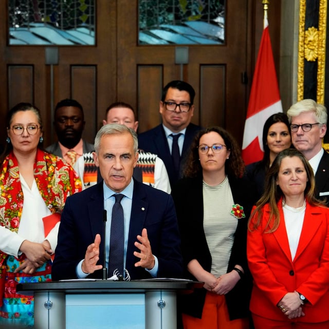 Prime Minister Mark Carney is joined by members of his cabinet and caucus as he speaks at a news conference in the Foyer of the House of Commons in Ottawa, after Bill C-5 passed in the House, on Friday, June 20, 2025. THE CANADIAN PRESS/Justin Tang