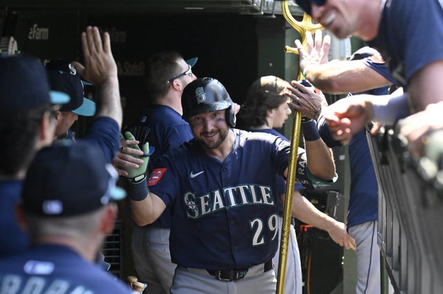 Jun 20, 2025; Chicago, Illinois, USA;  Seattle Mariners catcher Cal Raleigh (29) celebrates in the dugout after hitting a two run home run against the Chicago Cubs during the seventh inning at Wrigley Field. Mandatory Credit: Matt Marton-Imagn Images