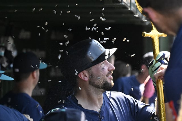 Jun 20, 2025; Chicago, Illinois, USA;  Seattle Mariners catcher Cal Raleigh (29) celebrates in the dugout after hitting a two run home run against the Chicago Cubs during the seventh inning at Wrigley Field. Mandatory Credit: Matt Marton-Imagn Images