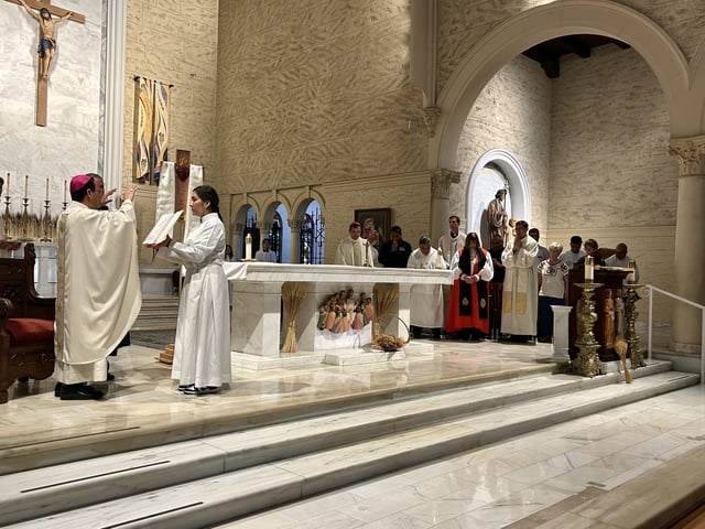 Bishop Michael Pham prays for a delegation of clergy and other immigrant supporters, Friday, at St. Joseph Cathedral, June 20, 2025.