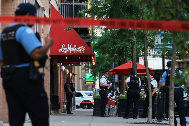 Police guard a shooting scene in the 400 block of North Wells Street on June 20, 2025, in Chicago. (John J. Kim/Chicago Tribune)