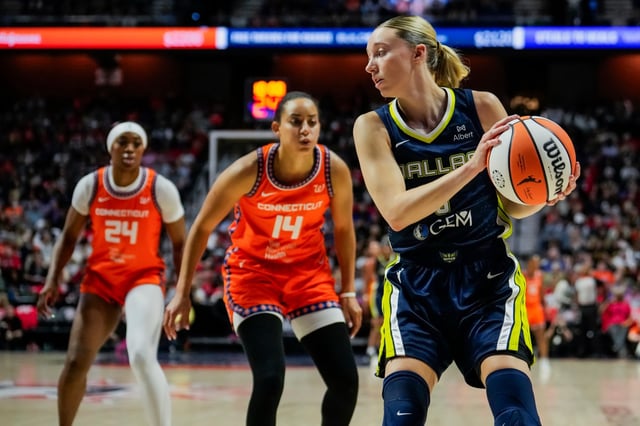 Paige Bueckers #5 of the Dallas Wings is defended by Bria Hartley #14 of the Connecticut Sun during the first half of a WNBA basketball game at Mohegan Sun Arena on June 20, 2025 in Uncasville, Connecticut. NOTE TO USER: User expressly acknowledges and agrees that, by downloading and or using this Photograph, user is consenting to the terms and conditions of the Getty Images License Agreement. (Photo by Joe Buglewicz/Getty Images)
