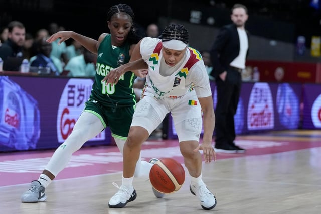 Senegal&#39;s Cierra Dillard, right, and Nigeria&#39;s Promise Amukamara chase a loose ball during an Olympic qualifier on Feb. 8, 2024, in Antwerp, Belgium. (Virginia Mayo/AP)