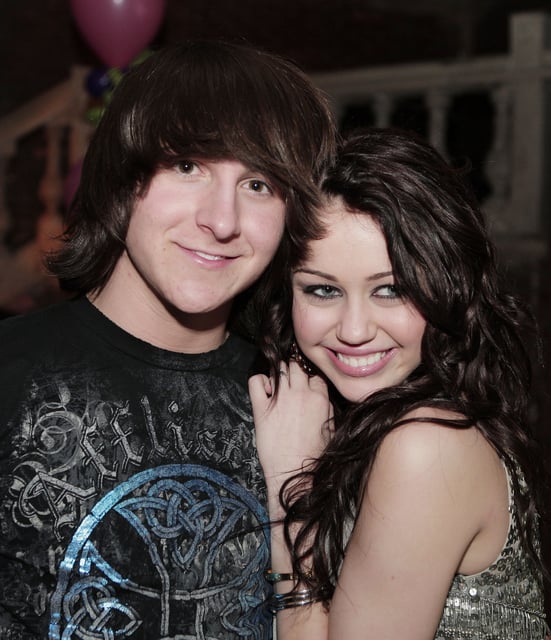 LOS ANGELES - JANUARY 17:  Actor Mitchel Musso (L) and actress/singer Miley Cyrus pose at the afterparty for the premiere of Walt Disney Pictures&#39; &#34;Hannah Montana &amp; Miley Cyrus: Best of Both Worlds Concert&#34; at The Highlands on January 17, 2008 in Los Angeles, California. (Photo by Kevin Winter/Getty Images)