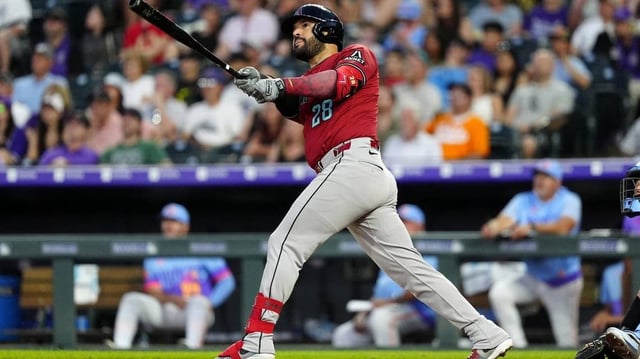 Jun 20, 2025; Denver, Colorado, USA; Arizona Diamondbacks third baseman Eugenio Suarez (28) hits a two run home run in the sixth inning against the Colorado Rockies at Coors Field. Mandatory Credit: Ron Chenoy-Imagn Images