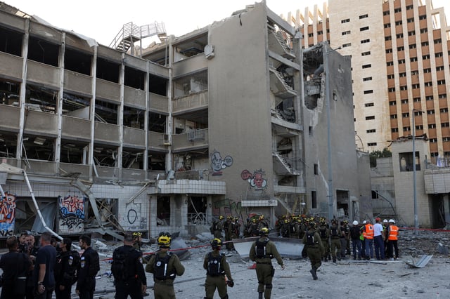 Emergency personnel work at an impact site following Iran's missile strike on Israel, amid the Iran-Israel conflict, in Haifa, Israel, June 20, 2025. REUTERS/Florion Goga/File Photo