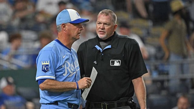 Kansas City Royals manager Matt Quatraro (33) talks with home plate umpire Ron Kulpa (46) in the ninth inning against the Boston Red Sox at Kauffman Stadium on May 10, 2025.