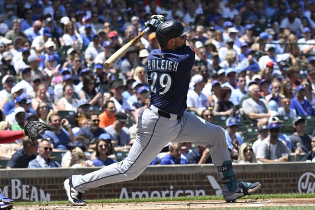 Jun 20, 2025; Chicago, Illinois, USA;  Seattle Mariners catcher Cal Raleigh (29) hits a home run against the Chicago Cubs during the first inning at Wrigley Field. Mandatory Credit: Matt Marton-Imagn Images