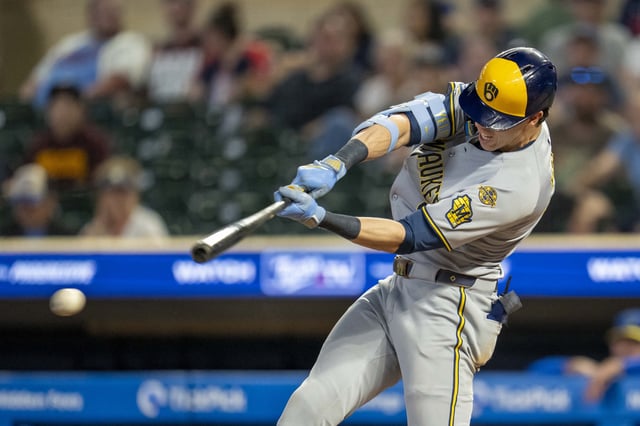 Jun 20, 2025; Minneapolis, Minnesota, USA; Milwaukee Brewers designated hitter Christian Yelich (22) hits a RBI single against the Minnesota Twins in the ninth inning at Target Field. Mandatory Credit: Jesse Johnson-Imagn Images