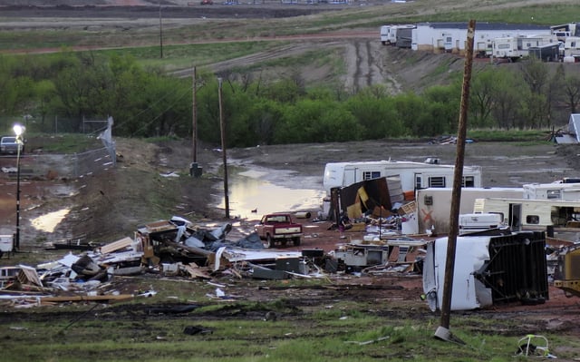 Debris is scattered Tuesday morning, May 27, 2014, after a tornado in Watford City, N.D.