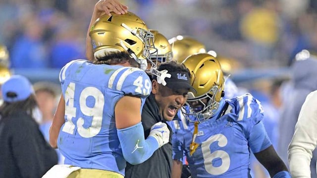 Nov 8, 2024; Pasadena, California, USA;   UCLA Bruins defensive coordinator Ikaika Malloe, center, celebrates with linebacker Carson Schwesinger (49) defensive back Jaylin Davies (6) after an interception in the second half against the Iowa Hawkeyes at the Rose Bowl. Mandatory Credit: Jayne Kamin-Oncea-Imagn Images