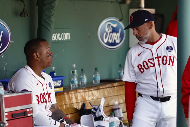 BOSTON, MA - APRIL 21: Rafael Devers #11 of the Boston Red Sox talks with manager Alex Cora #13 in the dugout during the seventh inning of their game against the Chicago White Sox at Fenway Park on April 21, 2025 in Boston, Massachusetts.