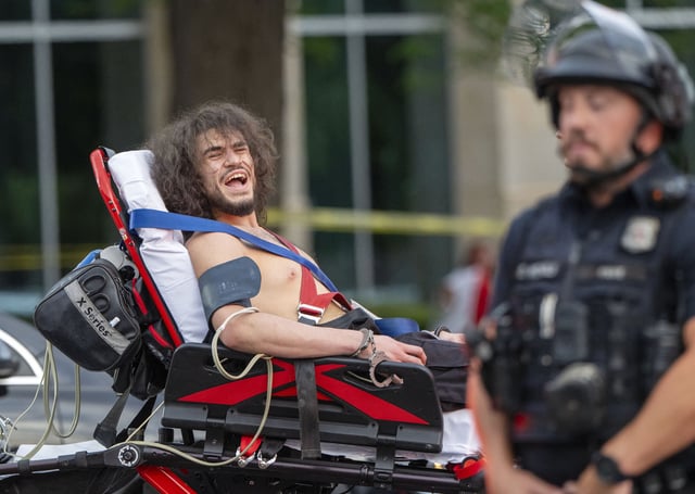 Arturo Gamboa is taken away in handcuffs on a gurney during the “No Kings” protest in Salt Lake City on Saturday, June 14, 2025.