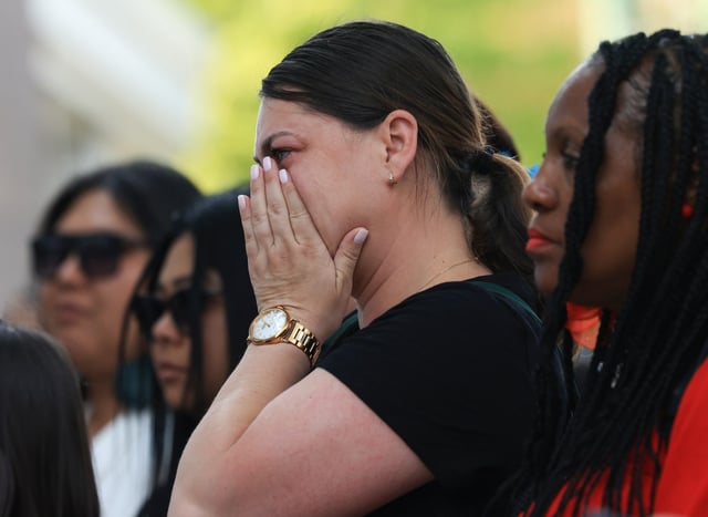 A mourner wipes tears during a prayer vigil for police Officer Krystal Rivera at the 6th District station, June 11, 2025, in Chicago. Rivera was fatally shot on June 5 by another officer as they responded to an investigation. (John J. Kim/Chicago Tribune)