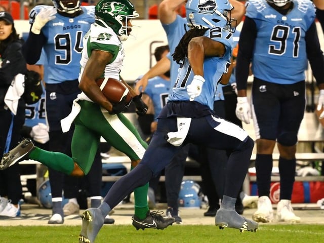 Saskatchewan Roughriders wide receiver Mario Alford (2) runs down the sidelines ahead of Toronto Argonauts defensive back Mark Milton (27) to score a touchdown during second half CFL football action in Toronto Friday, June 20, 2025.