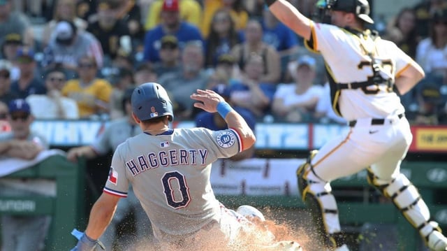 Jun 21, 2025; Pittsburgh, Pennsylvania, USA;  Texas Rangers left fielder Sam Haggerty (0) slides home to score a run as Pittsburgh Pirates catcher Henry Davis (32) takes an errant throw during the sixth inning  at PNC Park. Mandatory Credit: Charles LeClaire-Imagn Images