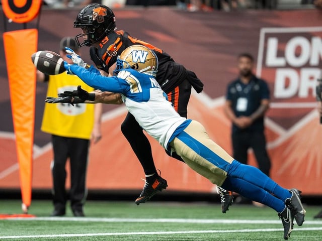 Winnipeg Blue Bombers' Deatrick Nichols, right, blocks a pass to B.C. Lions' Ayden Eberhardt during game in Vancouver on Saturday, June 21, 2025.