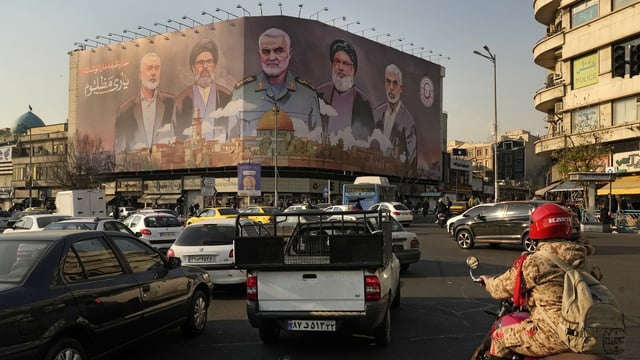 FILE - Vehicles drive on Enqelab-e-Eslami (Islamic Revolution) square in Tehran, Iran.