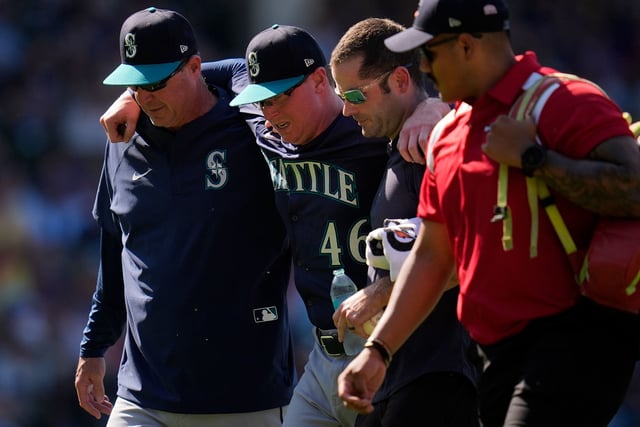Seattle Mariners pitcher Trent Thornton had to be helped off the field during the eighth inning at Wrigley Field.