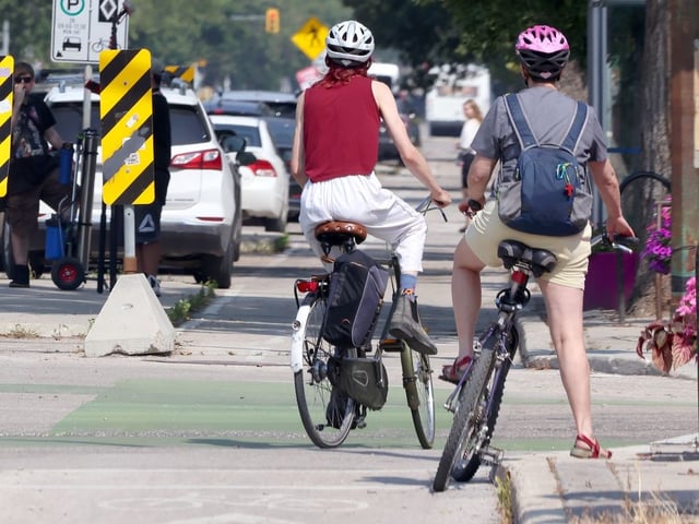 Business owners and residents gather near Marion Street to voice concerns over proposed bike lanes and parking loss under the city's 'Moving on Marion' plan.