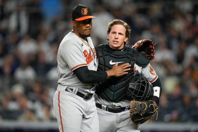 Orioles relief pitcher Yennier Cano, left, embraces catcher Adley Rutschman after escaping the seventh inning in Tuesday night&#39;s eventual 6-5 loss to the Yankees in 10 innings.