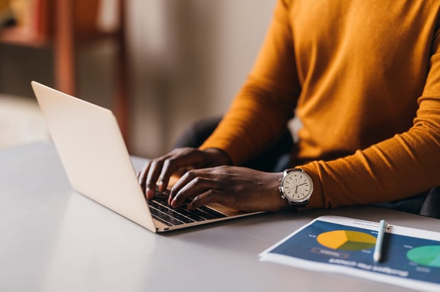 Focused African American woman typing on laptop, business concept