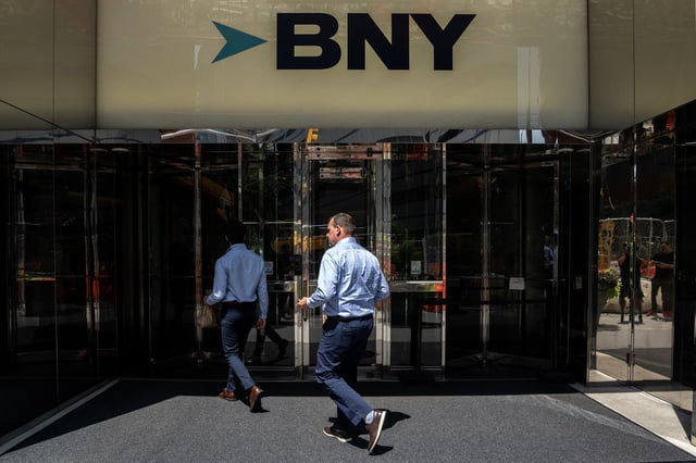 People walk near the office of BNY Mellon investment banking company in New York City, U.S., July 10, 2024.REUTERS/David 'Dee' Delgado/File Photo