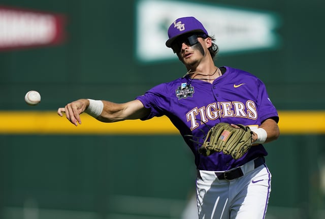 Tanner Reaves #5 of the LSU Tigers warms up prior to Game 1 of the NCAA College World Series baseball finals against the Coastal Carolina Chanticleers at Charles Schwab Field on June 21, 2025 in Omaha, Nebraska.