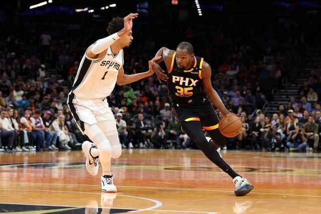 Kevin Durant #35 of the Phoenix Suns drives against Victor Wembanyama #1 of the San Antonio Spurs during the first half of the Emirates NBA Cup game at Footprint Center on December 03, 2024 in Phoenix, Arizona. The Suns defeated the Spurs 104-93.