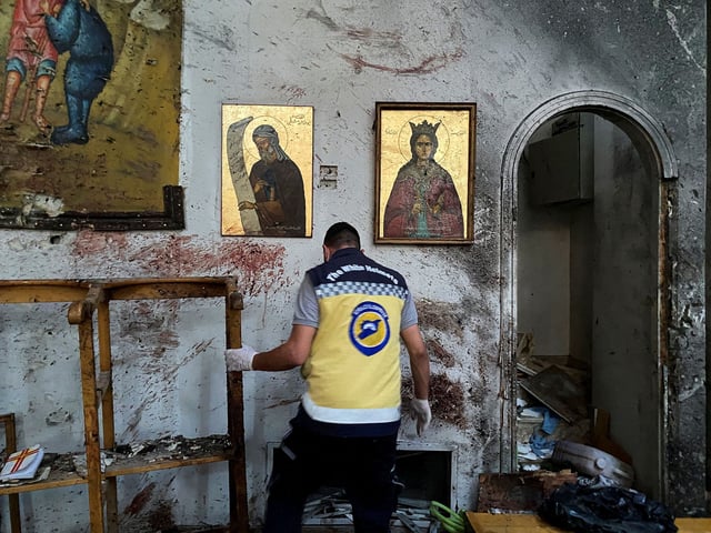 A civil defense member inspects the damage after a reported attack at the Mar Elias Church in the Dweila neighbourhood of Damascus, Syria, on June 22.