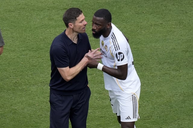 Jun 22, 2025; Charlotte, North Carolina, USA; Real Madrid C.F. defender Antonio Ruediger (22) and head coach Xabi Alonso react after the game during a group stage match of the 2025 FIFA Club World Cup at Bank of America Stadium. Mandatory Credit: Jim Dedmon-Imagn Images