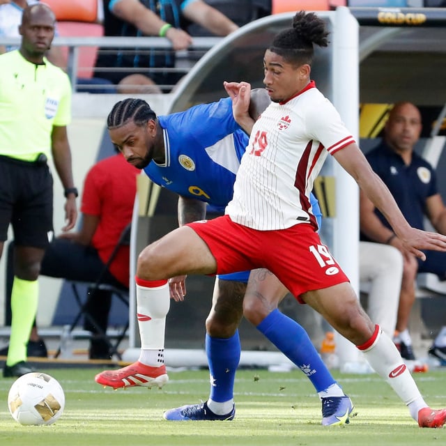 Canada's Nathan Saliba (19) pushes off Curacao's Jürgen Locadia, left, as he moves the ball during a CONCACAF Gold Cup soccer match Saturday, June 21, 2025, in Houston, Texas. THE CANADIAN PRESS/AP, Michael Wyke