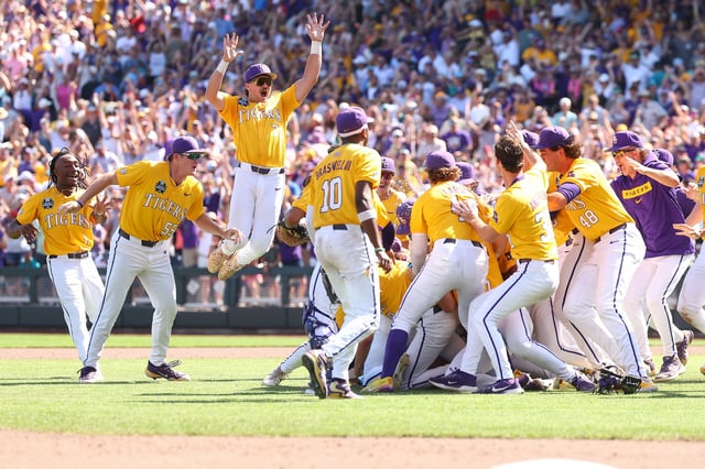 OMAHA, NEBRASKA - JUNE 22: Jake Brown #7 of the LSU Tigers leaps onto the dogpile in celebration after defeating the Coastal Carolina Chanticleers in game two of the Division I Baseball Championship held at Charles Schwab Field on June 22, 2025 in Omaha, Nebraska. (Photo by Tyler McFarland/NCAA Photos via Getty Images)