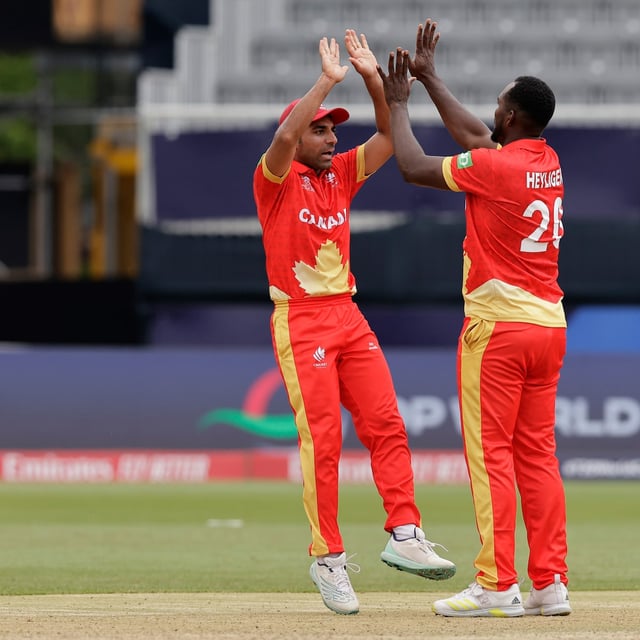 Canada's Dilon Heyliger, right, celebrates with captain Saad Bin Zafar after the dismissal of Pakistan's captain Babar Azam during the ICC Men's T20 World Cup cricket match between Pakistan and Canada at the Nassau County International Cricket Stadium in Westbury, New York, Tuesday, June 11, 2024. (AP Photo/Adam Hunger)