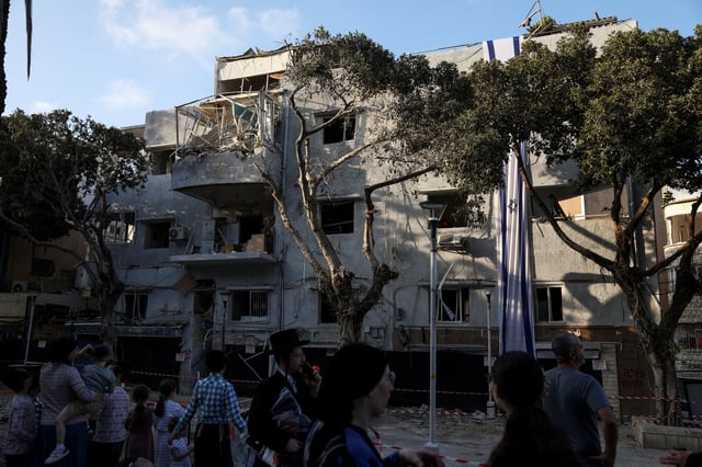 People gather at an impact site following Iran's strike on Israel, amid the Iran-Israel conflict, in Haifa, Israel, June 22, 2025. REUTERS/Florion Goga