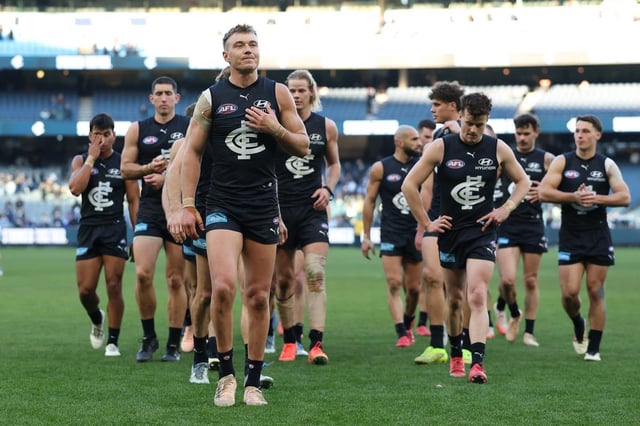 Patrick Cripps leads Carlton off the field after the loss to the Roos.