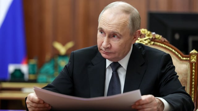 Russian President Vladimir Putin attends a meeting.