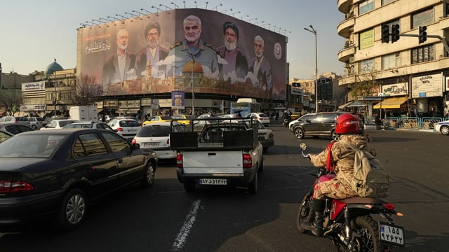 Vehicles drive on Enqelab-e-Eslami (Islamic Revolution) square in Tehran, Iran.