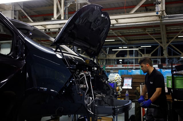 An employee works on the automobile assembly line of Renault Trafic vehicles at the Renault Sandouville car factory, near Le Havre, France, March 29, 2024. REUTERS/Sarah Meyssonnier/File Photo