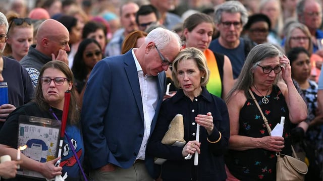 Minnesota Gov. Tim Walz and wife Gwen stand with the crowd during a candlelight vigil for Melissa and Mark Hortman at the State Capitol building on Wednesday, June 18, 2025, in St. Paul, Minnesota. (Aaron Lavinsky/The Minnesota Star Tribune/TNS)