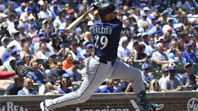 Jun 20, 2025; Chicago, Illinois, USA;  Seattle Mariners catcher Cal Raleigh (29) hits a home run against the Chicago Cubs during the first inning at Wrigley Field. Mandatory Credit: Matt Marton-Imagn Images
