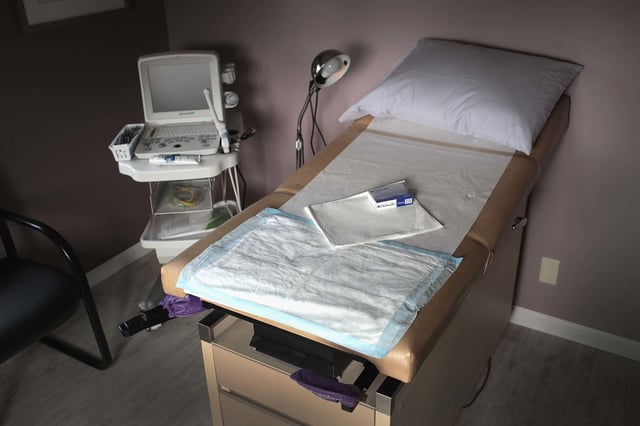 An ultrasound machine sits next to an exam table in an examination room at Whole Woman's Health of South Bend on June 19, 2019 in South Bend, Ind.