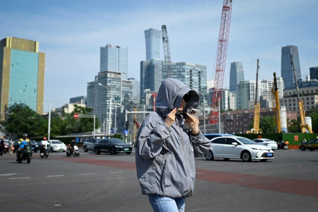 Beijing officials encouraged people to limit outdoor activity and drink fluids to avoid heastroke