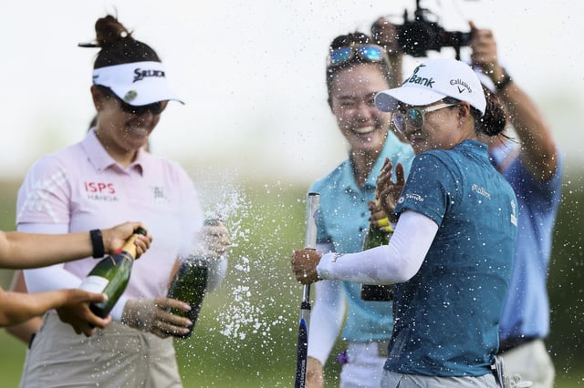 FRISCO, TEXAS - JUNE 22: Minjee Lee of Australia is doused with champagne on the 18th hole green after winning the KPMG Women&#39;s PGA Championship 2025 at Fields Ranch East at PGA Frisco on June 22, 2025 in Frisco, Texas. (Photo by Alex Slitz/Getty Images)
