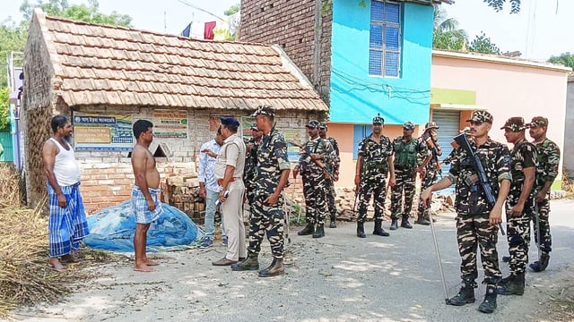 Debagram Police and Central Forces talk to the general public during a route march ahead of the Kaliganj Assembly constituency Bypoll, in Nadia on Sunday. 