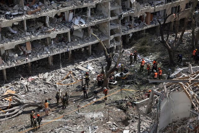 Emergency personnel work at an impact site following a missile attack from Iran on Israel, amid the Iran-Israel conflict, in Tel Aviv, Israel, June 22, 2025. REUTERS/Violeta Santos Moura/File Photo