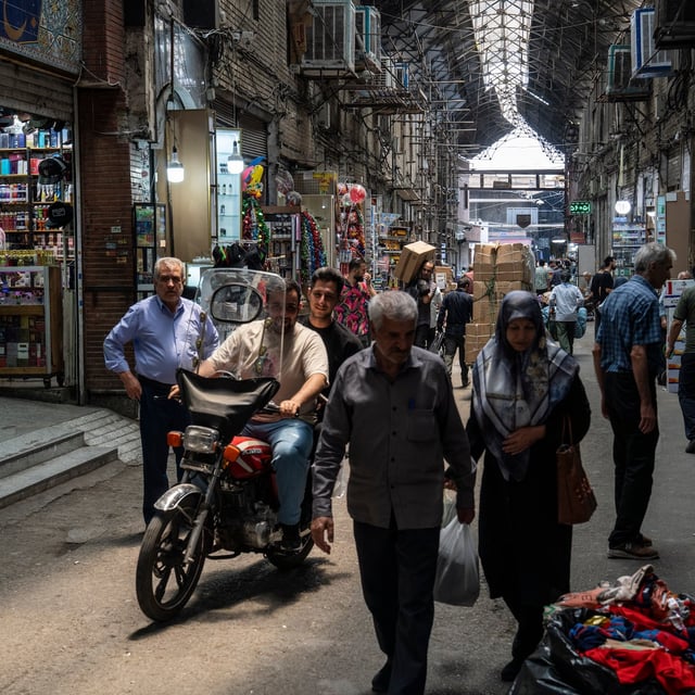 TEHRAN, IRAN - JUNE 22: People walk through a partially-shuttered Tehran Market on June 22, 2025 in Tehran, Iran. In the early hours of June 22, the United States dropped a series of bombs on several alleged nuclear facilities in Iran, joining Israel's ongoing war with the country. Iran responded with a barrage of missiles at Israel and promised retaliation against US interests in the region. (Photo by Getty Images)