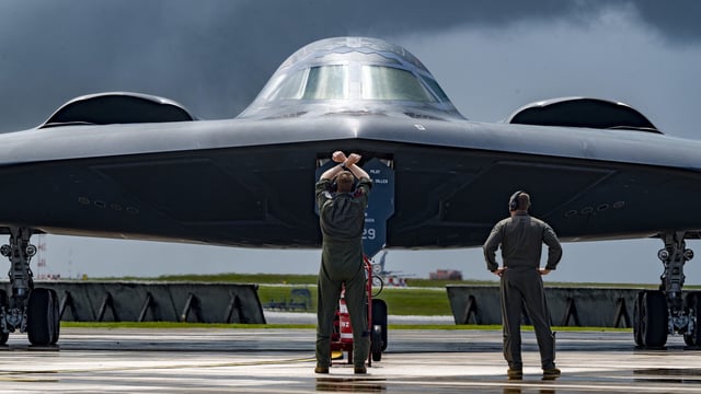 Maj. Stuart Shippee, a B-2 Spirt pilot assigned to the 13th Bomber Squadron, marshals a B-2 Spirit, deployed from Whiteman Air Force Base, Mo., at Andersen Air Force Base, Guam, in support of exercise Valiant Shield 24, June 13, 2024. Valiant Shield, a counter-maritime mission, provides valuable training opportunities to improve interoperability and demonstrate capable forces operating anywhere, anytime to meet any challenge decisively. (U.S. Air Force photo by Staff Sgt. Kristen Heller)